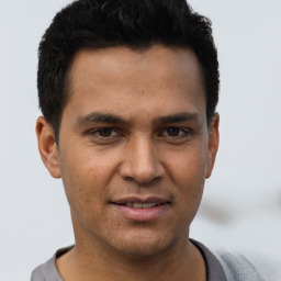 Joyful asian young-adult male with short  brown hair and brown eyes