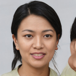 Joyful asian young-adult female with medium  black hair and brown eyes