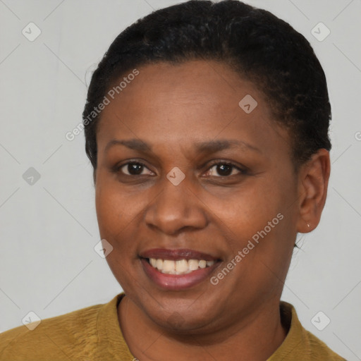 Joyful black young-adult female with short  black hair and brown eyes