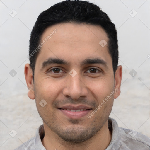 Joyful latino young-adult male with short  black hair and brown eyes