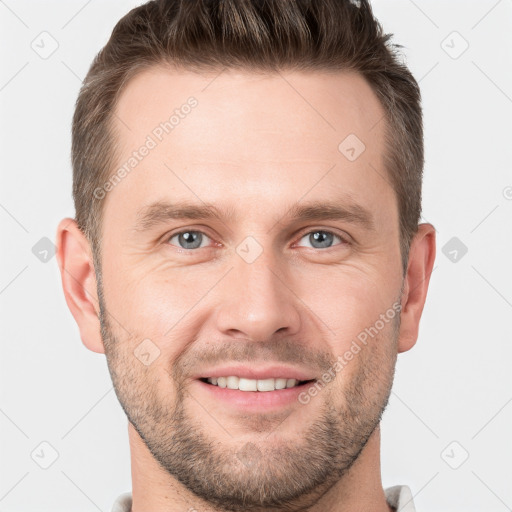 Joyful white young-adult male with short  brown hair and grey eyes