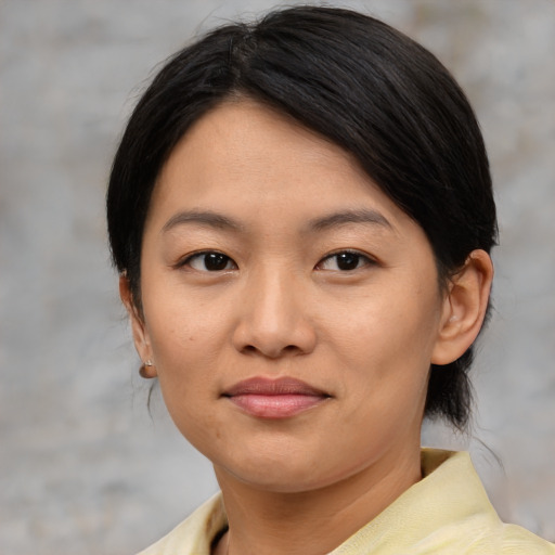Joyful asian young-adult female with medium  brown hair and brown eyes