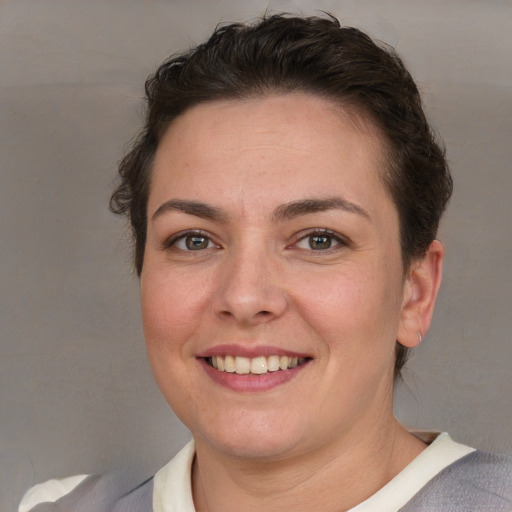 Joyful white young-adult female with short  brown hair and grey eyes