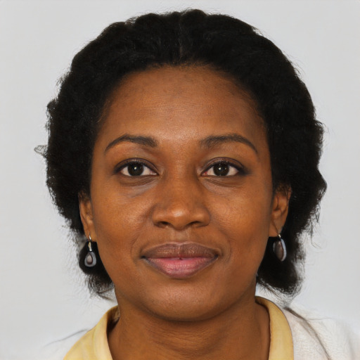 Joyful black adult female with short  black hair and brown eyes