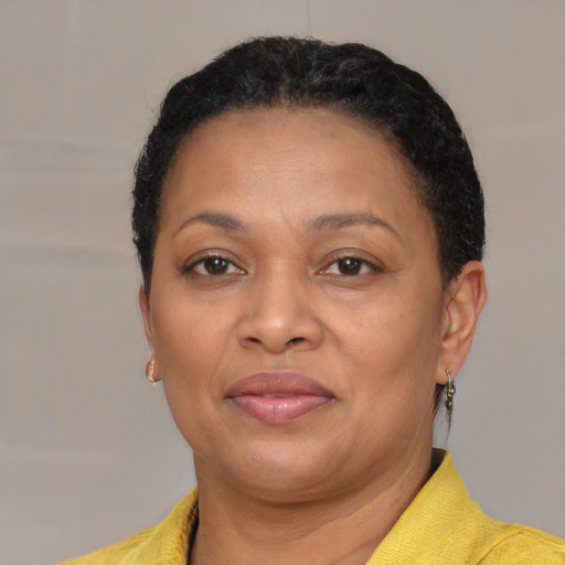 Joyful latino adult female with short  brown hair and brown eyes