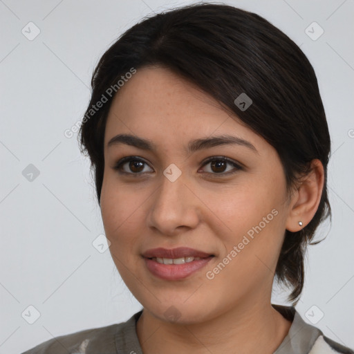 Joyful latino young-adult female with medium  brown hair and brown eyes