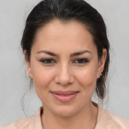 Joyful latino young-adult female with medium  brown hair and brown eyes