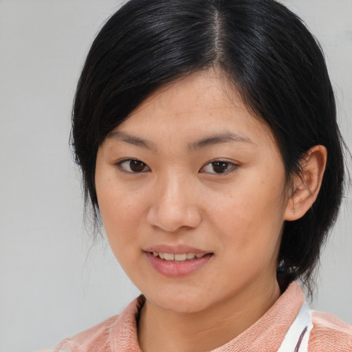 Joyful asian young-adult female with medium  brown hair and brown eyes