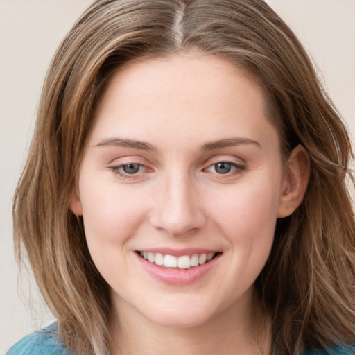 Joyful white young-adult female with medium  brown hair and blue eyes