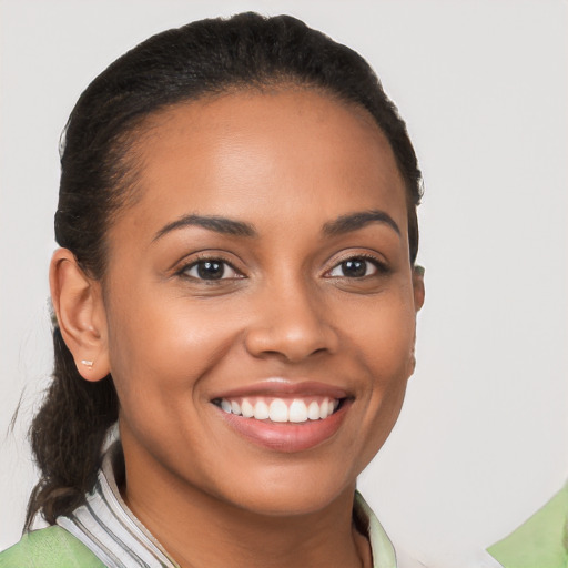 Joyful latino young-adult female with short  brown hair and brown eyes