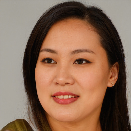 Joyful asian young-adult female with long  brown hair and brown eyes