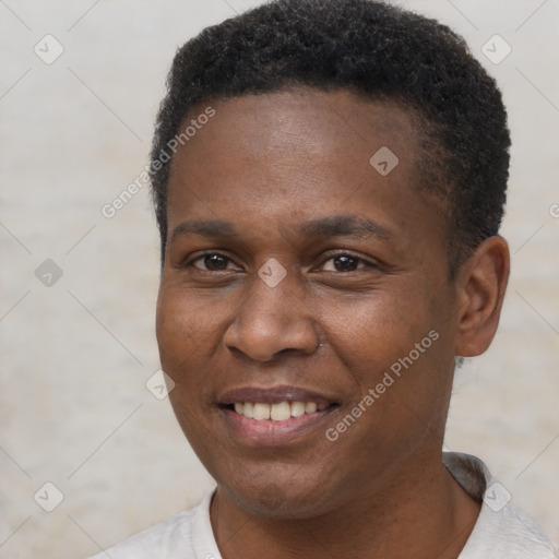 Joyful black adult male with short  brown hair and brown eyes