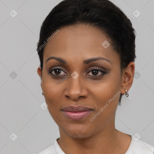 Joyful black young-adult female with short  black hair and brown eyes