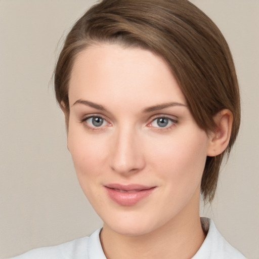 Joyful white young-adult female with medium  brown hair and green eyes