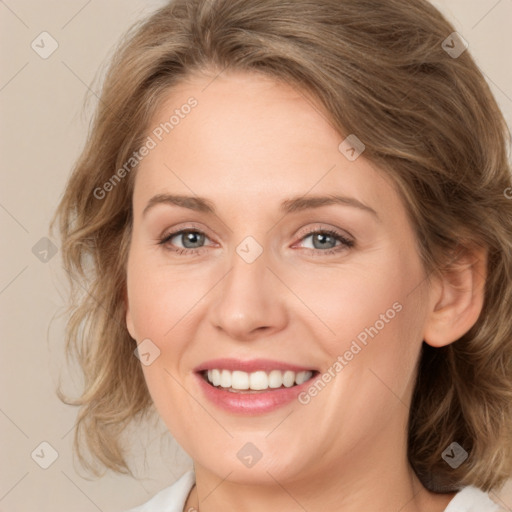 Joyful white young-adult female with medium  brown hair and green eyes