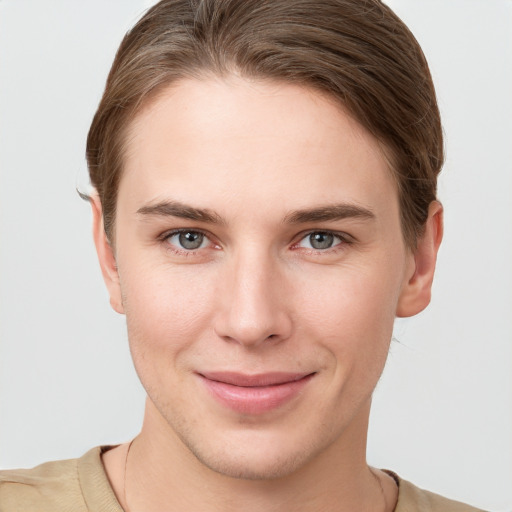 Joyful white young-adult female with short  brown hair and grey eyes