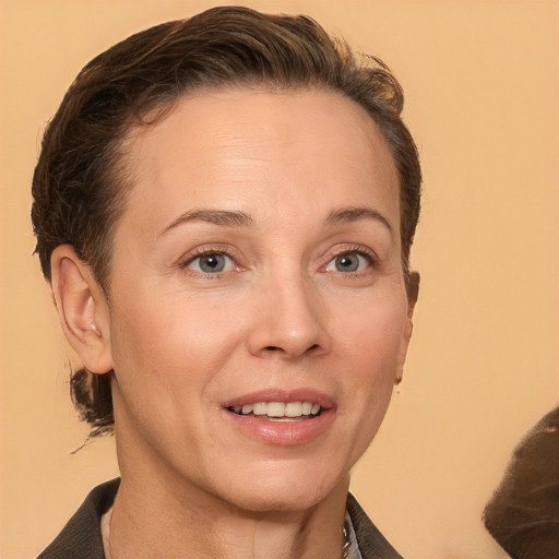 Joyful white adult female with short  brown hair and brown eyes