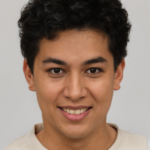Joyful latino young-adult male with short  brown hair and brown eyes
