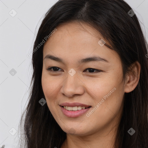 Joyful asian young-adult female with long  brown hair and brown eyes