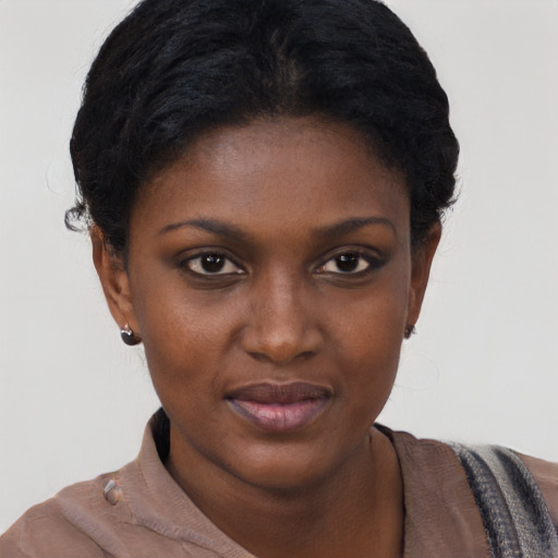 Joyful black young-adult female with short  black hair and brown eyes
