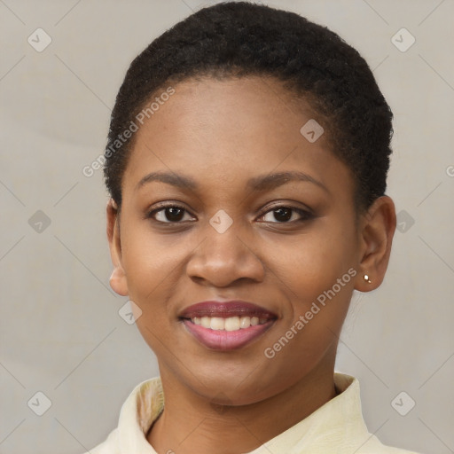 Joyful black young-adult female with short  brown hair and brown eyes