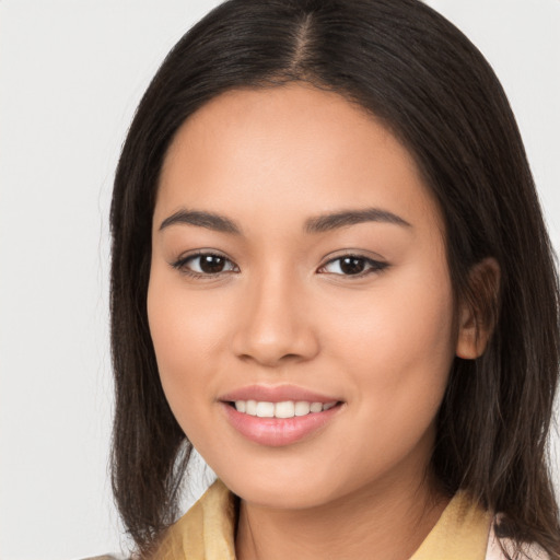 Joyful white young-adult female with long  brown hair and brown eyes