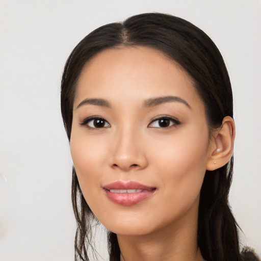 Joyful latino young-adult female with long  black hair and brown eyes