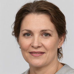 Joyful white adult female with medium  brown hair and grey eyes