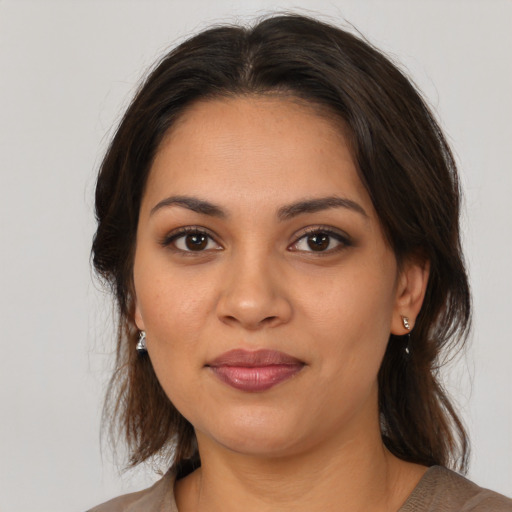 Joyful latino young-adult female with medium  brown hair and brown eyes