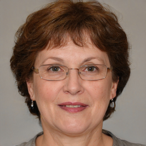 Joyful white middle-aged female with medium  brown hair and blue eyes