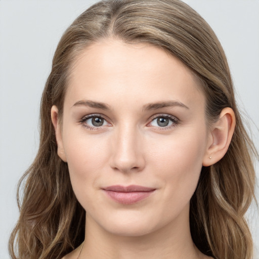 Joyful white young-adult female with long  brown hair and grey eyes