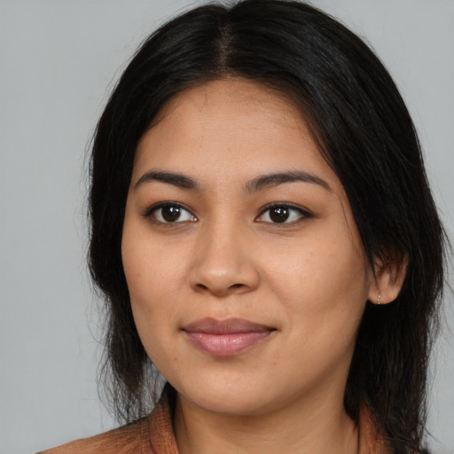 Joyful asian young-adult female with long  black hair and brown eyes