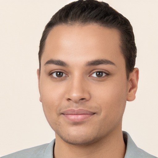 Joyful white young-adult male with short  brown hair and brown eyes