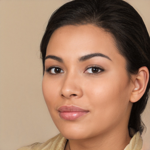 Joyful latino young-adult female with long  brown hair and brown eyes