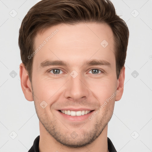 Joyful white young-adult male with short  brown hair and grey eyes