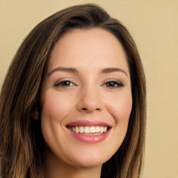 Joyful white young-adult female with long  brown hair and green eyes