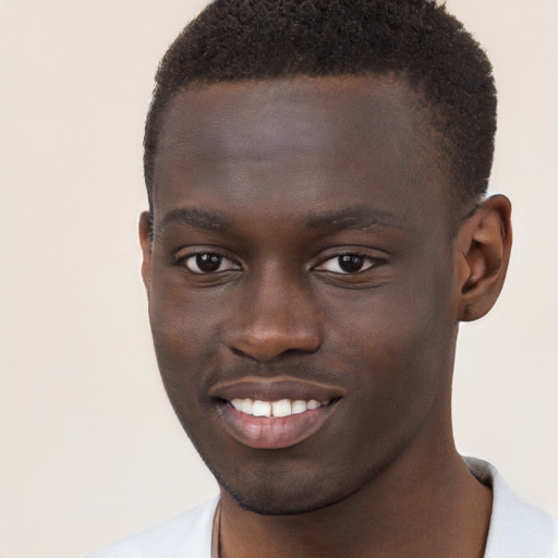 Joyful black young-adult male with short  brown hair and brown eyes