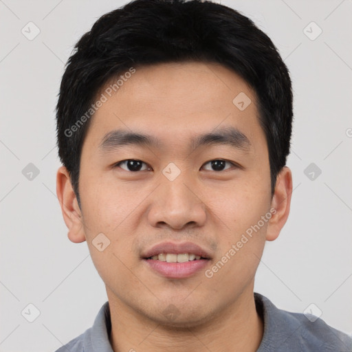 Joyful asian young-adult male with short  black hair and brown eyes