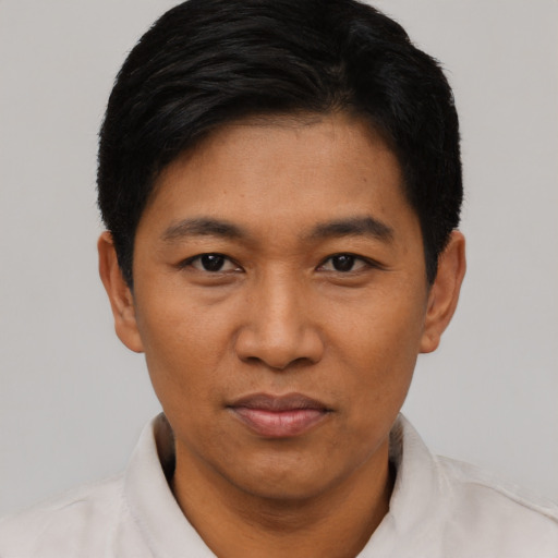 Joyful asian young-adult male with short  black hair and brown eyes