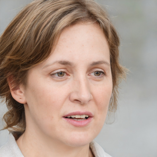 Joyful white adult female with medium  brown hair and blue eyes