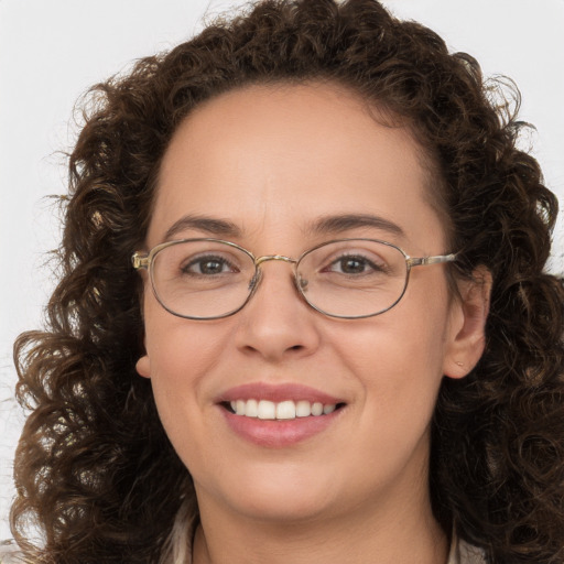 Joyful white adult female with long  brown hair and brown eyes