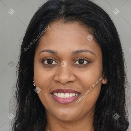 Joyful black young-adult female with long  brown hair and brown eyes