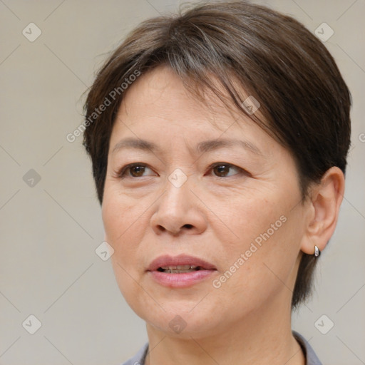 Joyful white adult female with short  brown hair and brown eyes