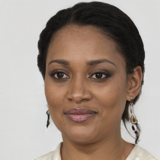 Joyful black adult female with short  black hair and brown eyes
