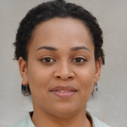 Joyful black young-adult female with medium  brown hair and brown eyes