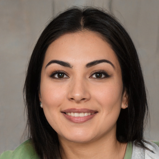 Joyful white young-adult female with medium  brown hair and brown eyes