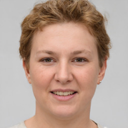 Joyful white young-adult female with short  brown hair and grey eyes