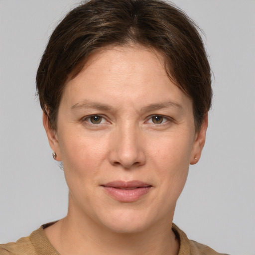 Joyful white young-adult female with short  brown hair and grey eyes