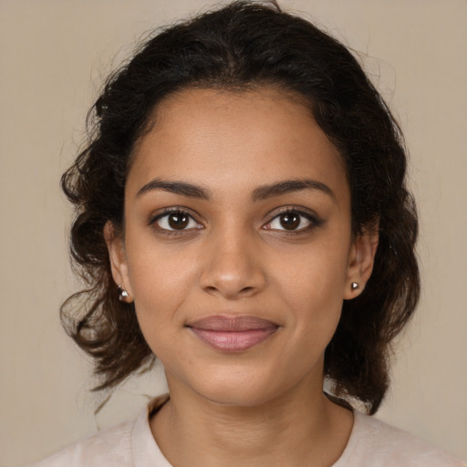 Joyful black young-adult female with medium  brown hair and brown eyes