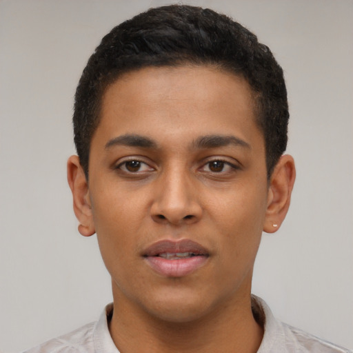 Joyful latino young-adult male with short  brown hair and brown eyes